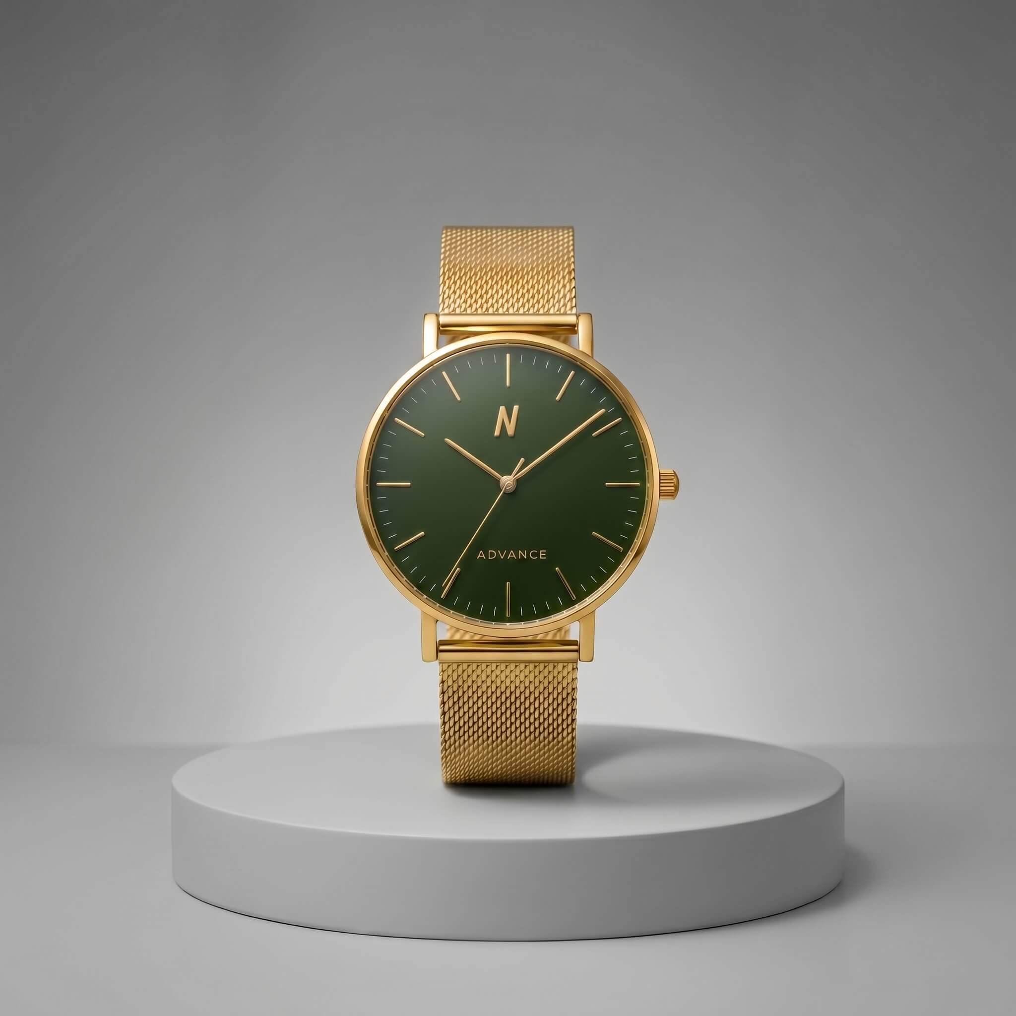 A advance mineral green mesh 40mm gold-tone mesh strap watch with a dark green dial and gold-tone hands, displayed on a round gray pedestal against a gray gradient background. The dial features a gold 'N' logo and 'ADVANCE' text.