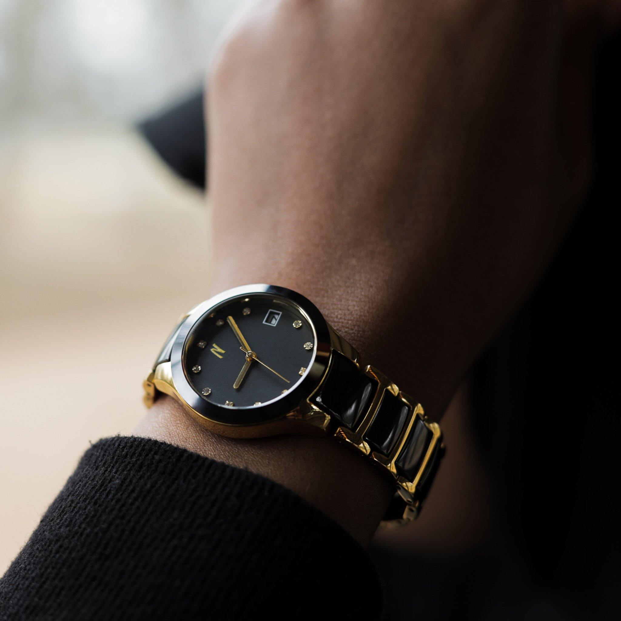 34MM Petite Link Queen women's black and gold ceramic watch featuring quartz movement