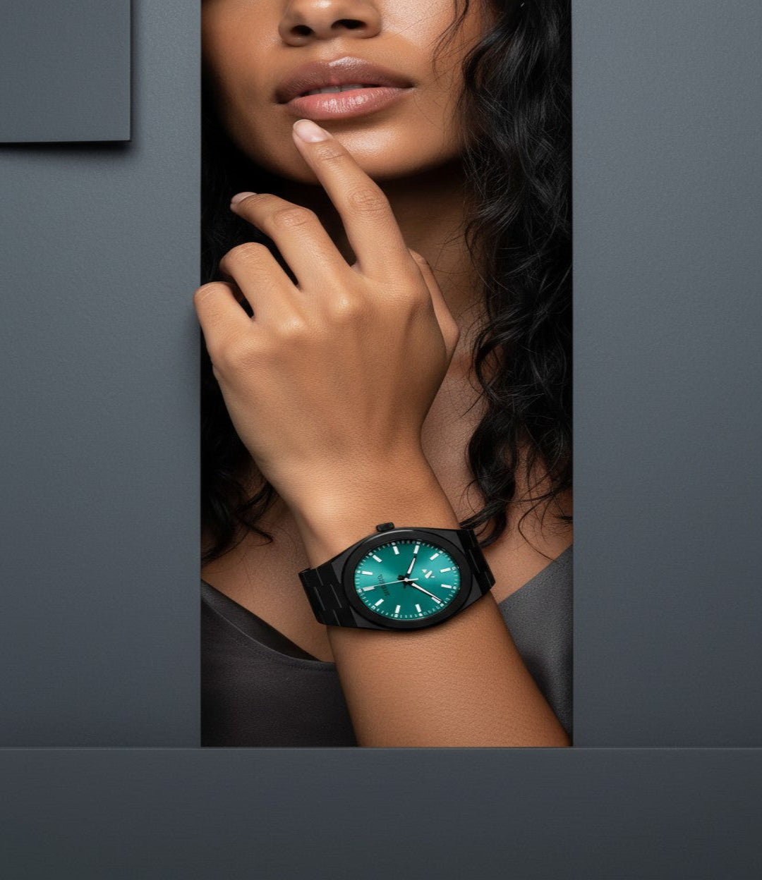 Woman wearing a black elevate link maldives swiss movement 42mm watch with a aqua face on a gray background