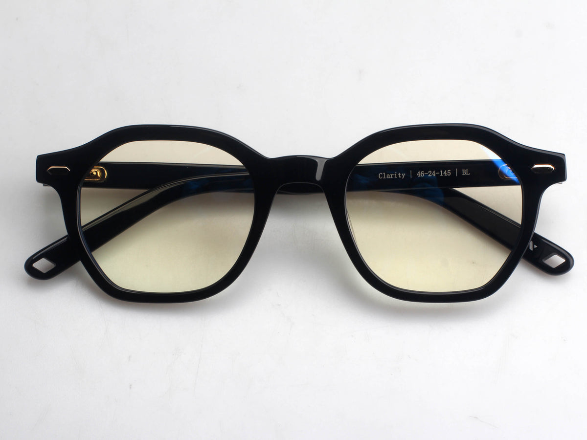 Black acetate square eyeglass frames with yellow-tinted lenses, shown from the front on a white background.